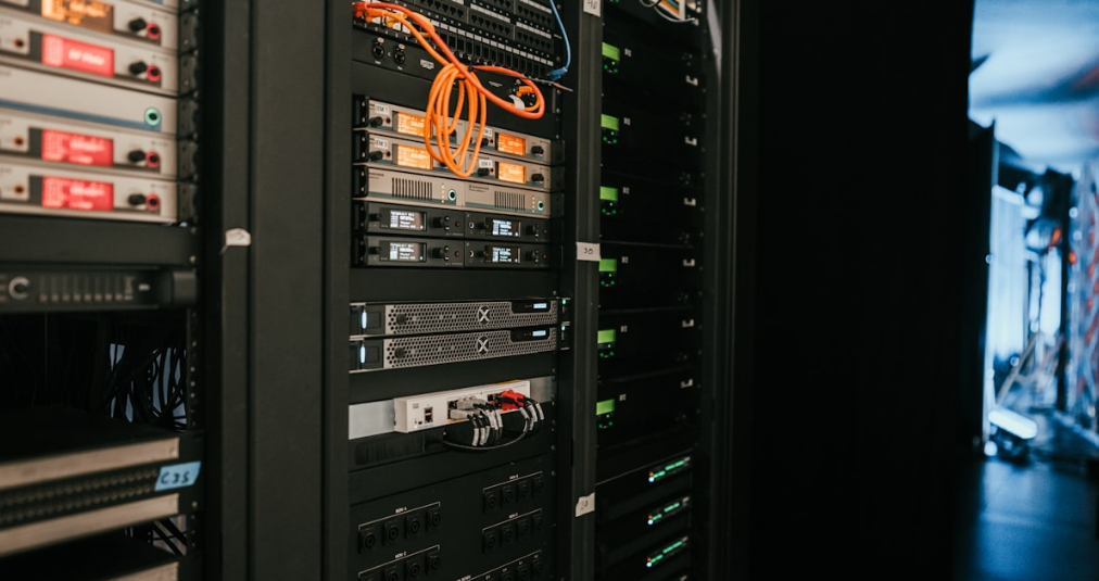 Close-up of blue and yellow network cables connected to server infrastructure in a data centre